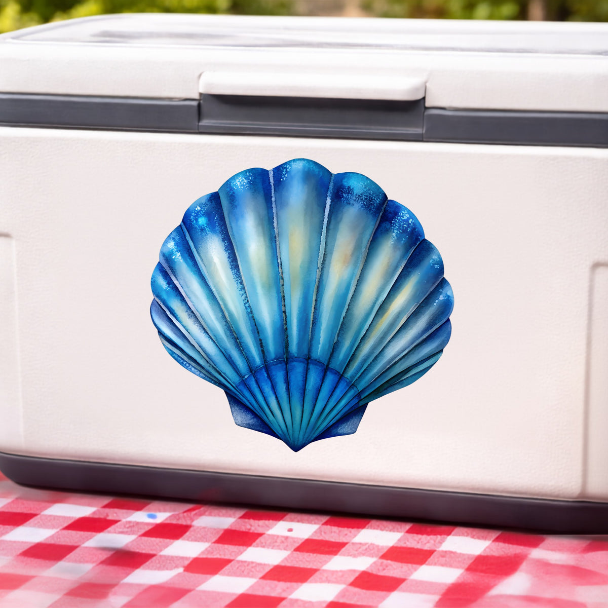 Blue Scallop Seashell UV DTF sticker applied to a white cooler on a red gingham cloth