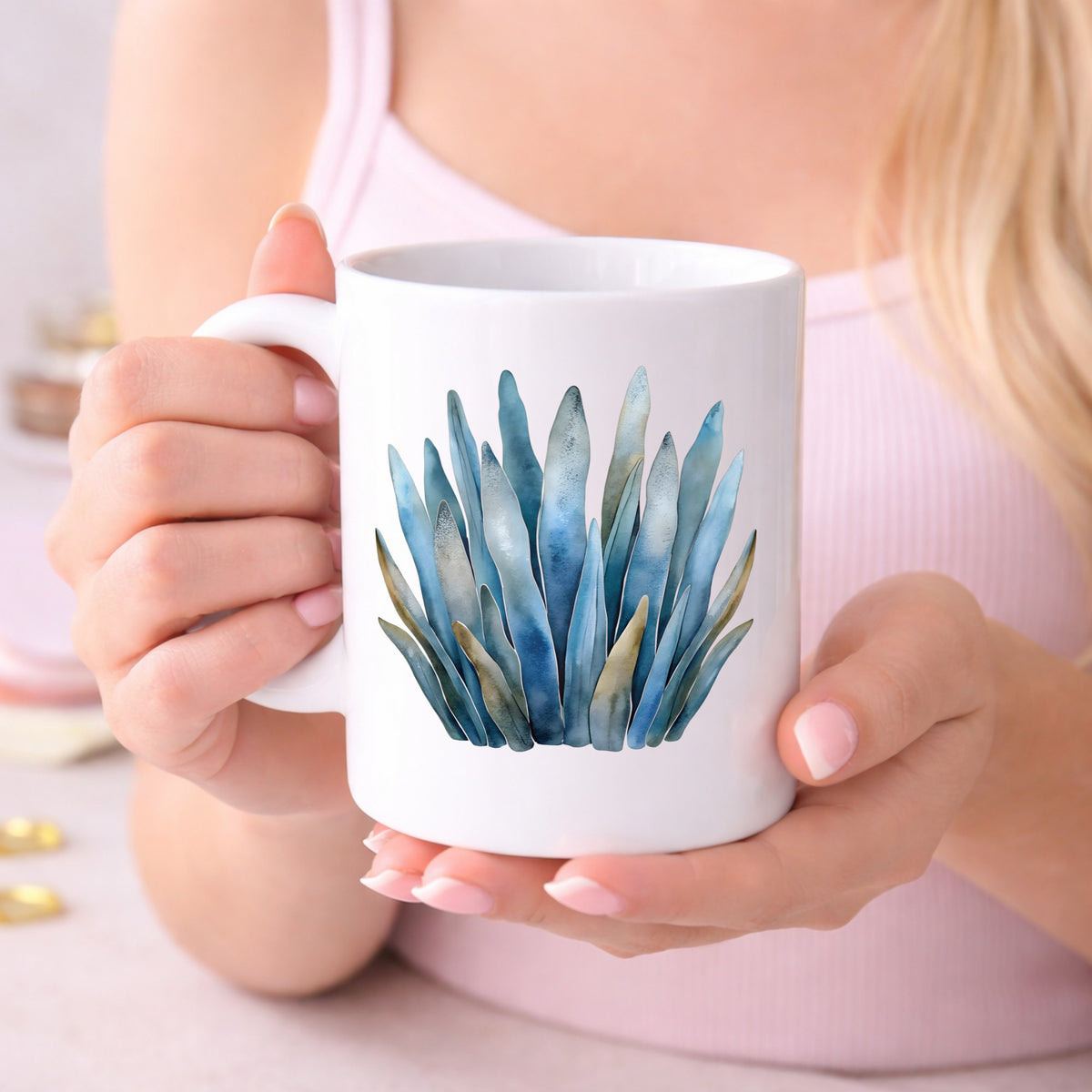 Blue Coastal Sea Grass UV DTF sticker applied to a white coffee mug held in both hands