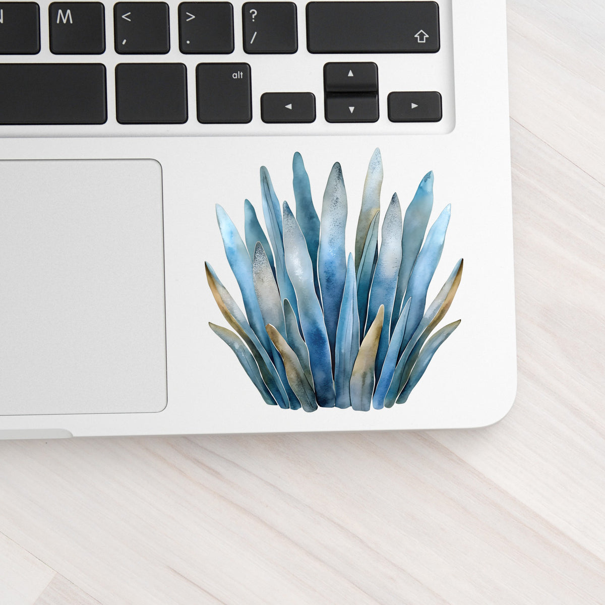 Blue Coastal Sea Grass UV DTF sticker applied to a silver laptop beside the keyboard