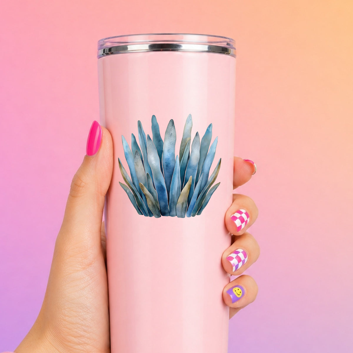 Blue Coastal Sea Grass UV DTF sticker applied to a tall pink tumbler on a pink and orange background