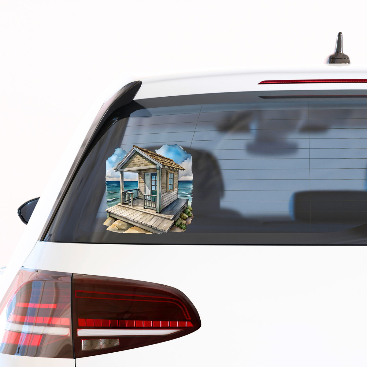 Beach Cottage Porch Ocean View UV DTF sticker applied to the rear window of a white car