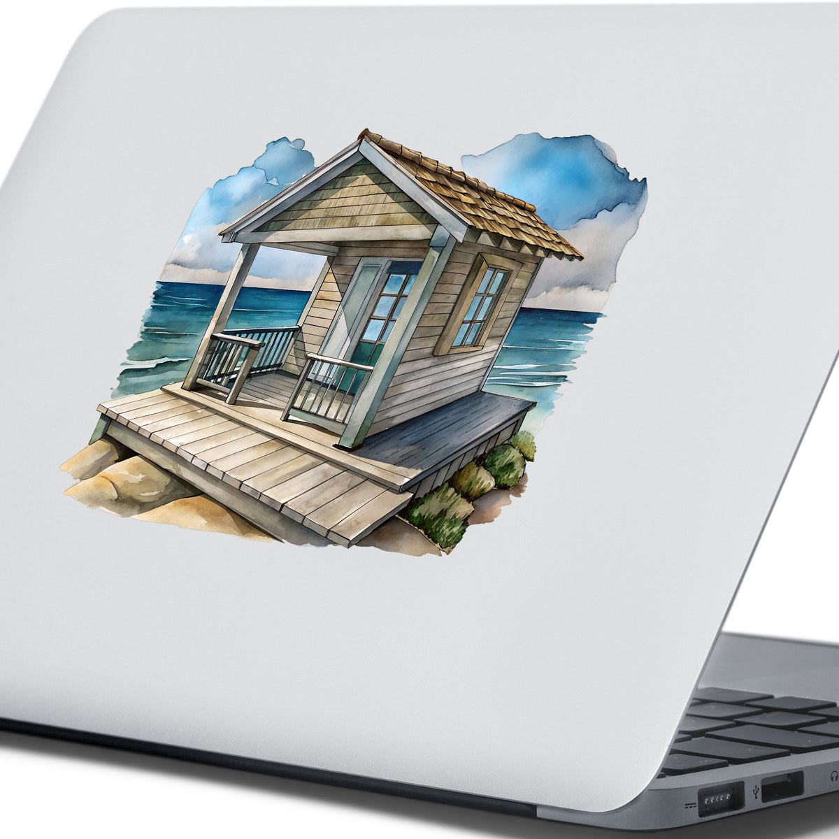 Beach Cottage Porch Ocean View UV DTF sticker applied to the lid of a silver laptop