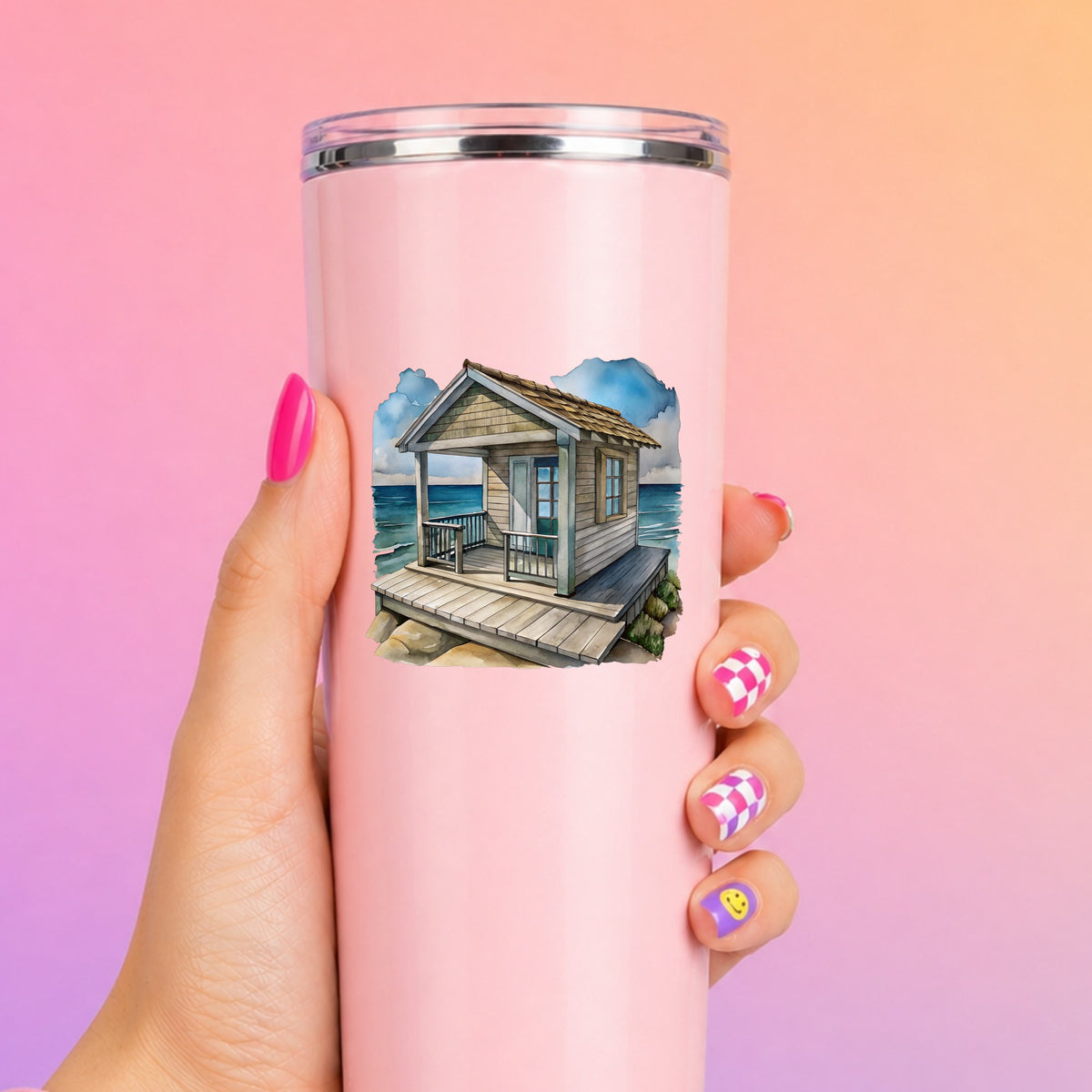 Beach Cottage Porch Ocean View UV DTF sticker applied to a tall pink tumbler on a pink and orange background