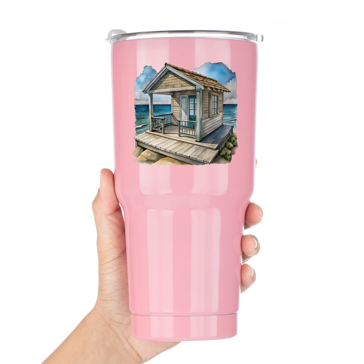 Beach Cottage Porch Ocean View UV DTF sticker applied to a pink tumbler held against a white background
