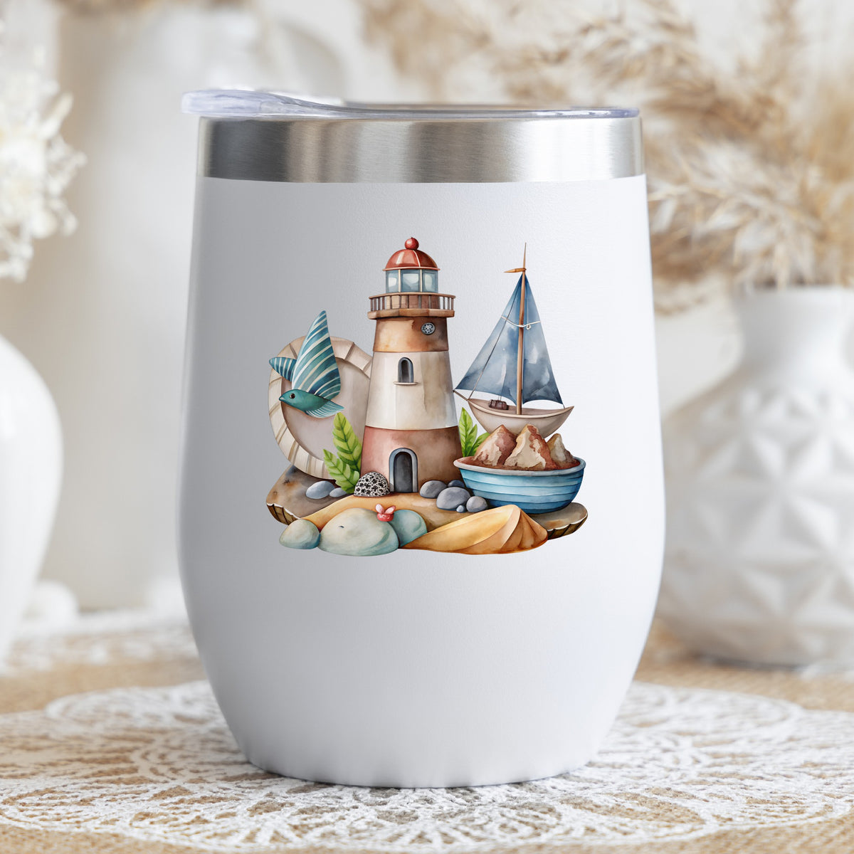 Lighthouse Sailboat Seaside Scene UV DTF sticker applied to a white stemless tumbler with a lid