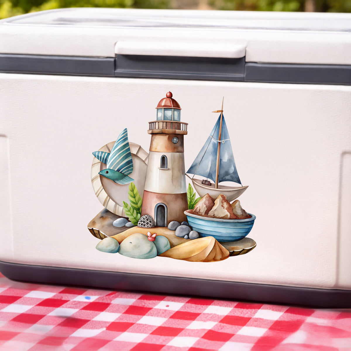 Lighthouse Sailboat Seaside Scene UV DTF sticker applied to a white cooler on a red gingham cloth
