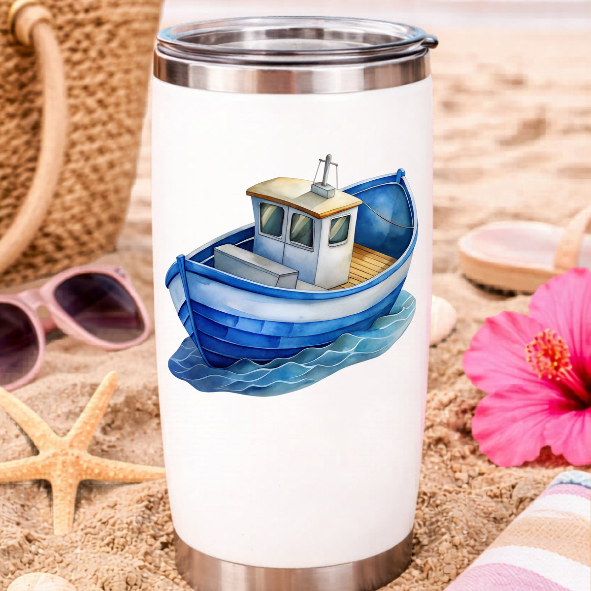 Blue Fishing Boat On Waves UV DTF sticker applied to a white travel tumbler on beach sand