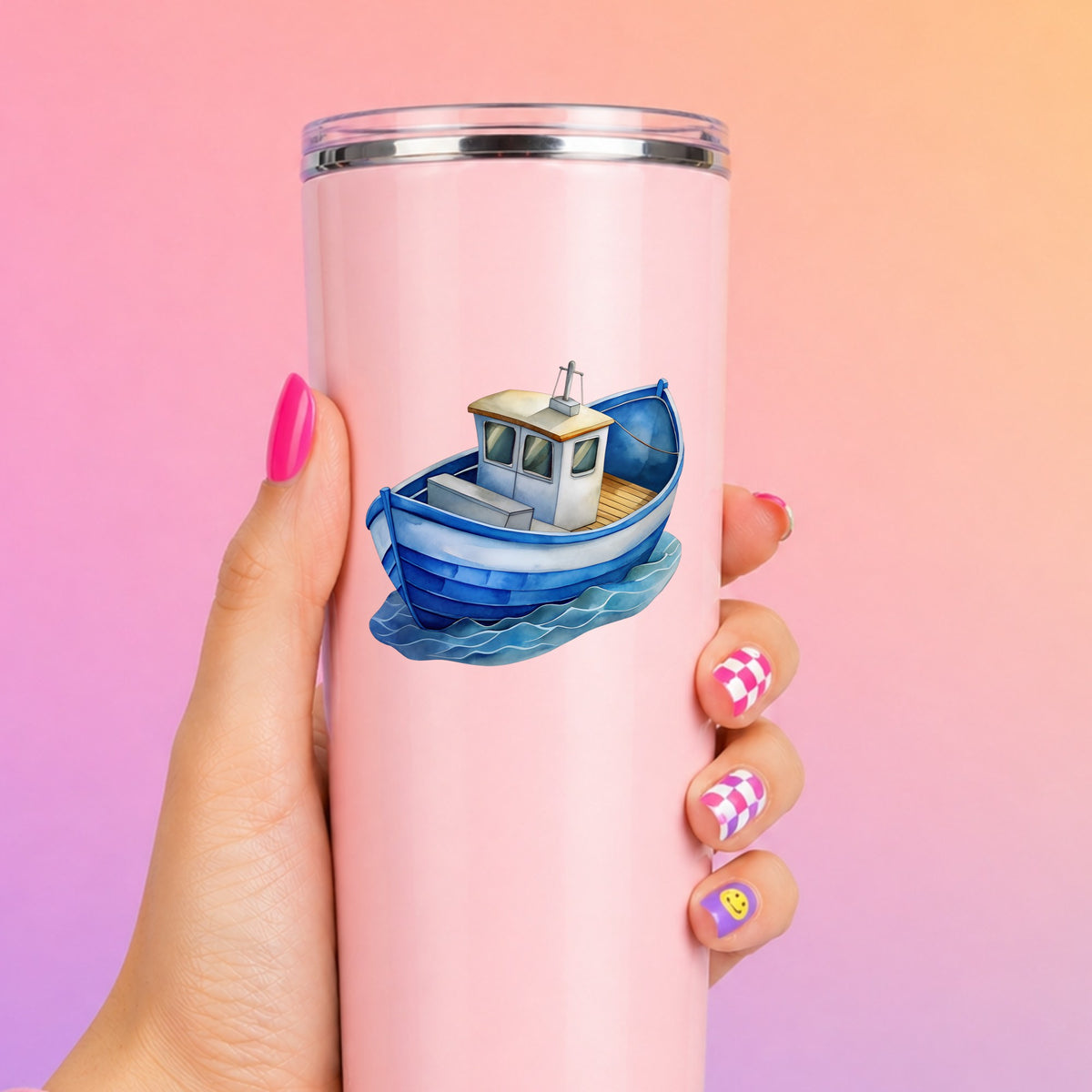 Blue Fishing Boat On Waves UV DTF sticker applied to a tall pink tumbler on a pink and orange background