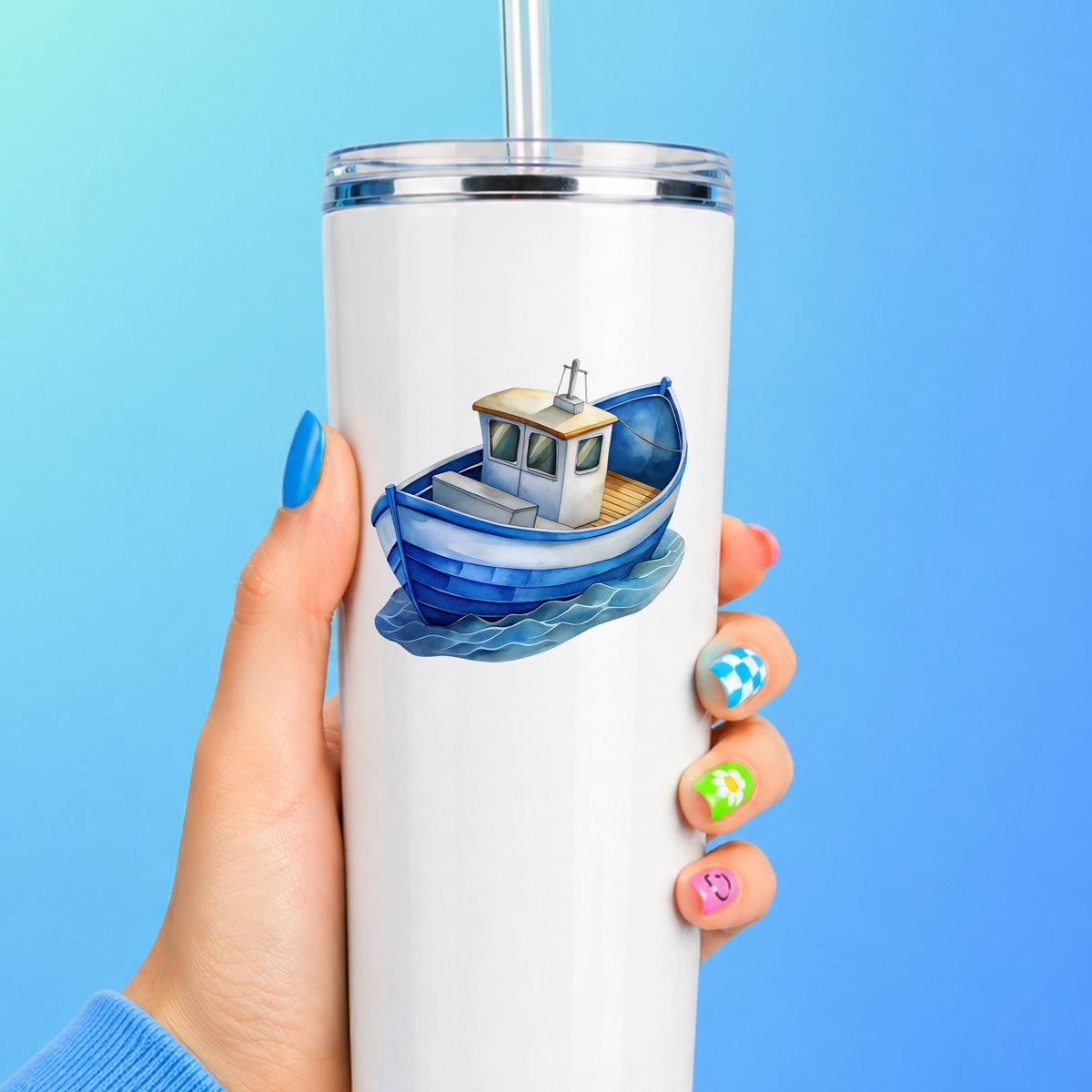 Blue Fishing Boat On Waves UV DTF sticker applied to a white straw tumbler on a blue background