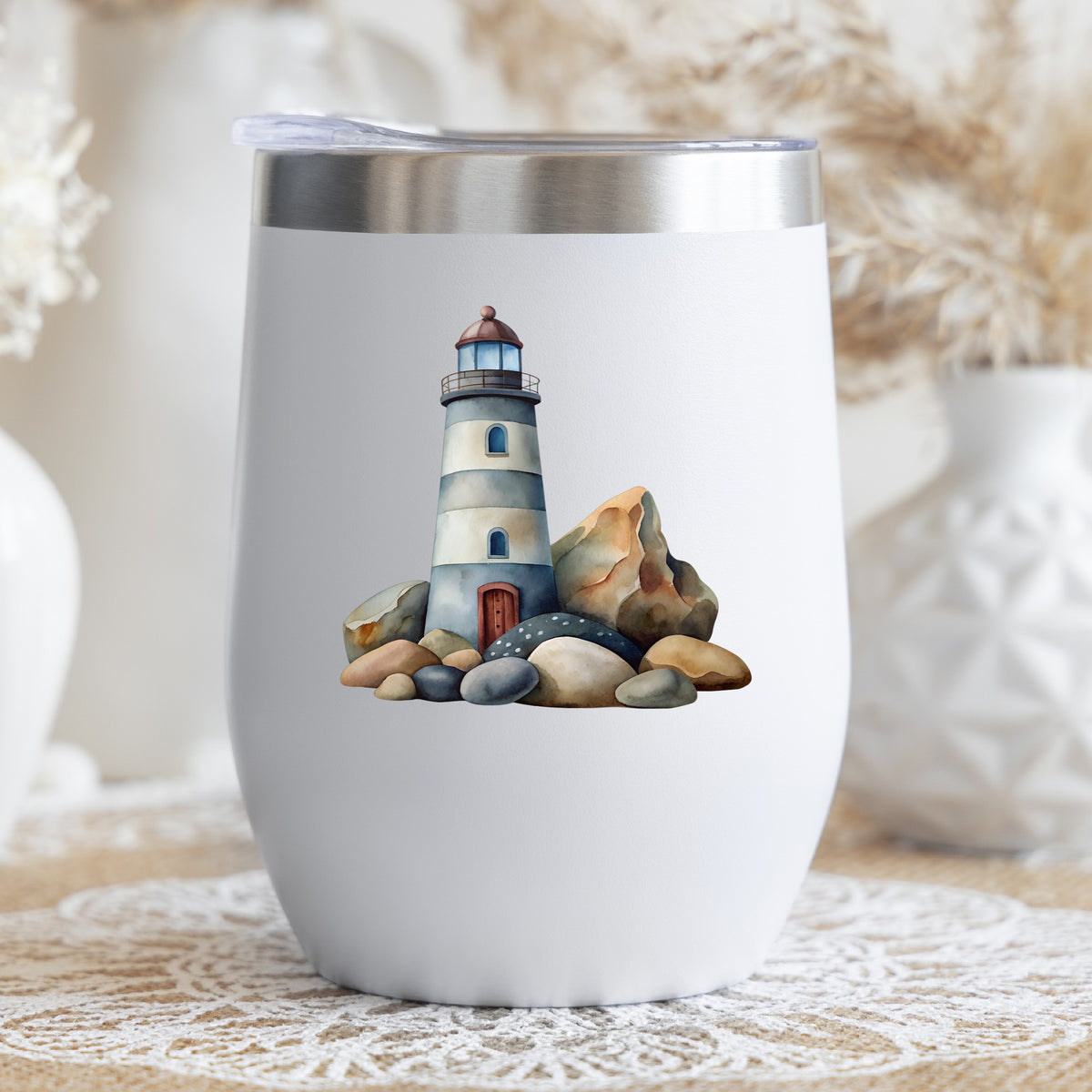Lighthouse On Rocky Shore UV DTF sticker applied to a white stemless tumbler with a lid