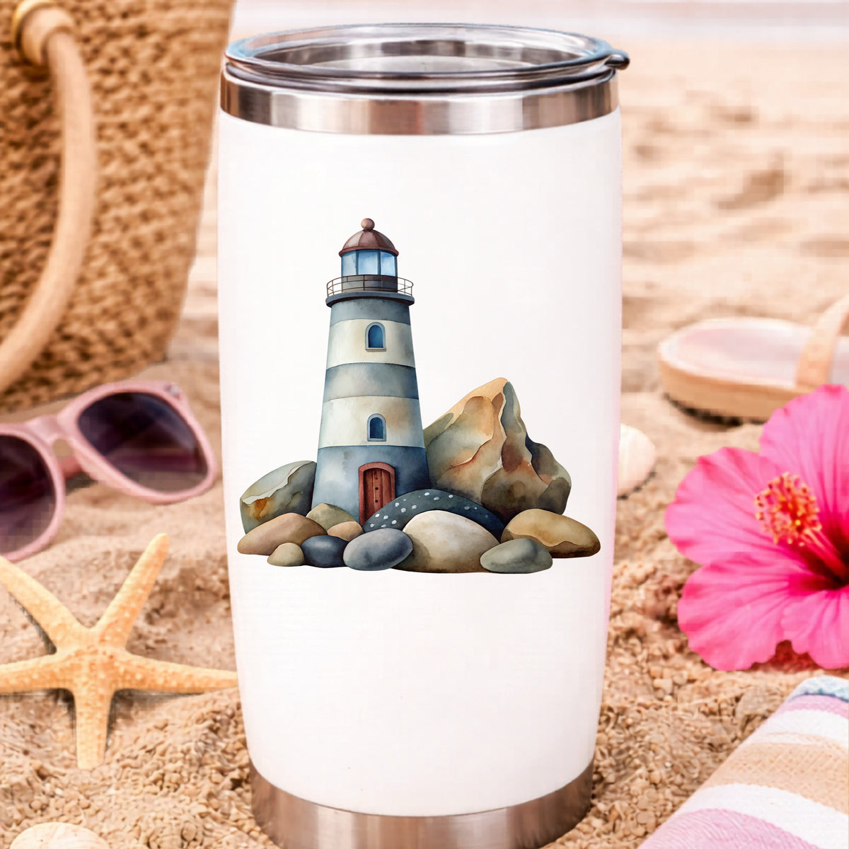 Lighthouse On Rocky Shore UV DTF sticker applied to a white travel tumbler on beach sand