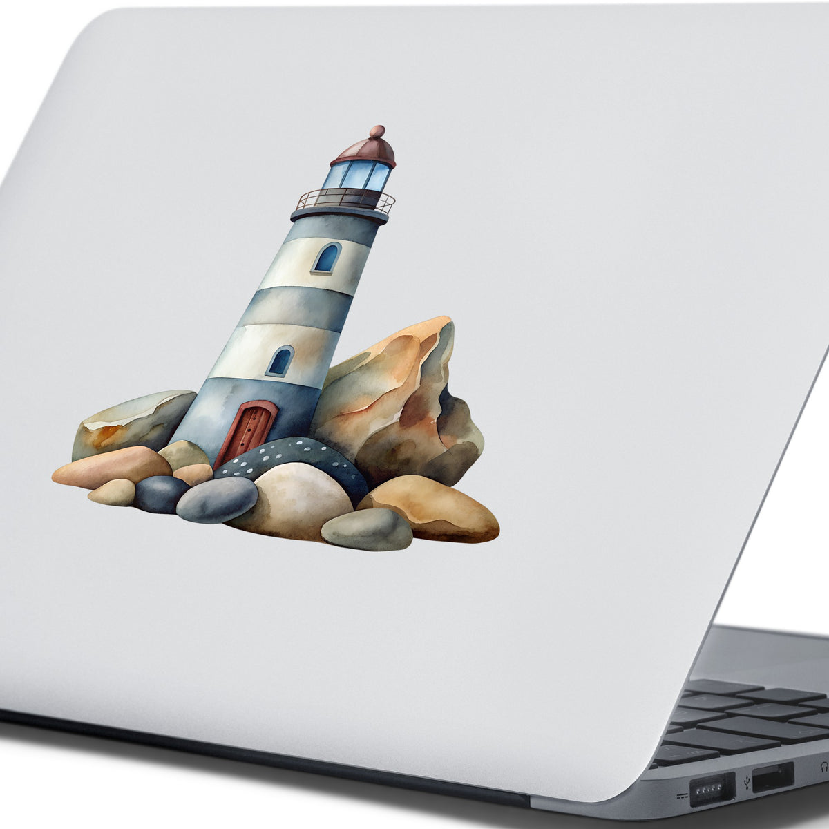 Lighthouse On Rocky Shore UV DTF sticker applied to the lid of a silver laptop