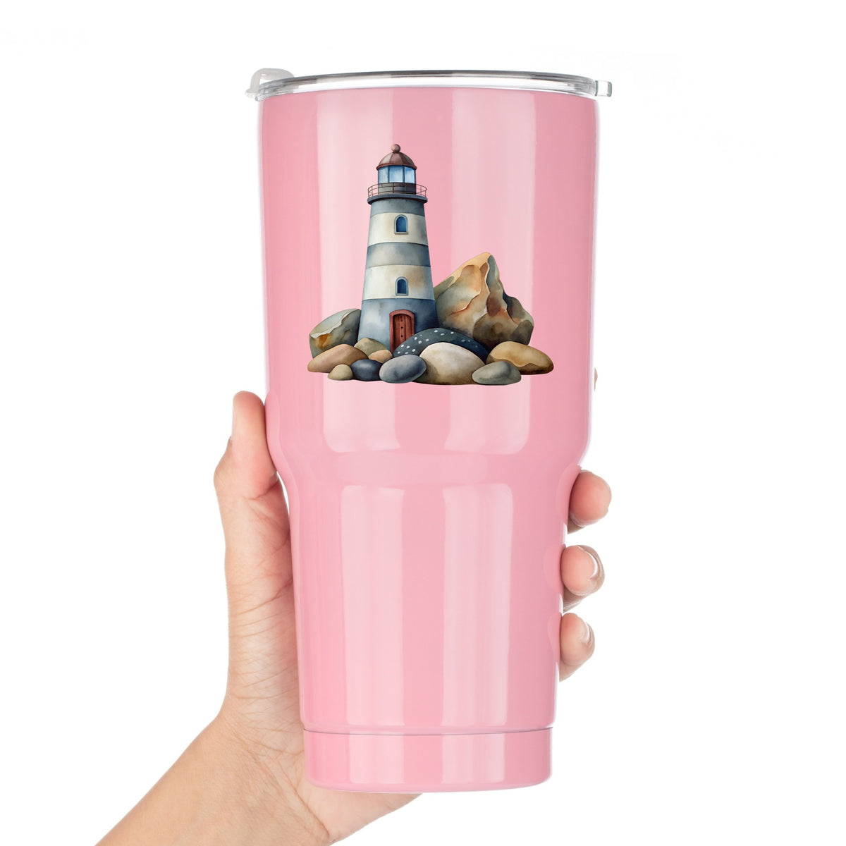 Lighthouse On Rocky Shore UV DTF sticker applied to a pink tumbler held against a white background