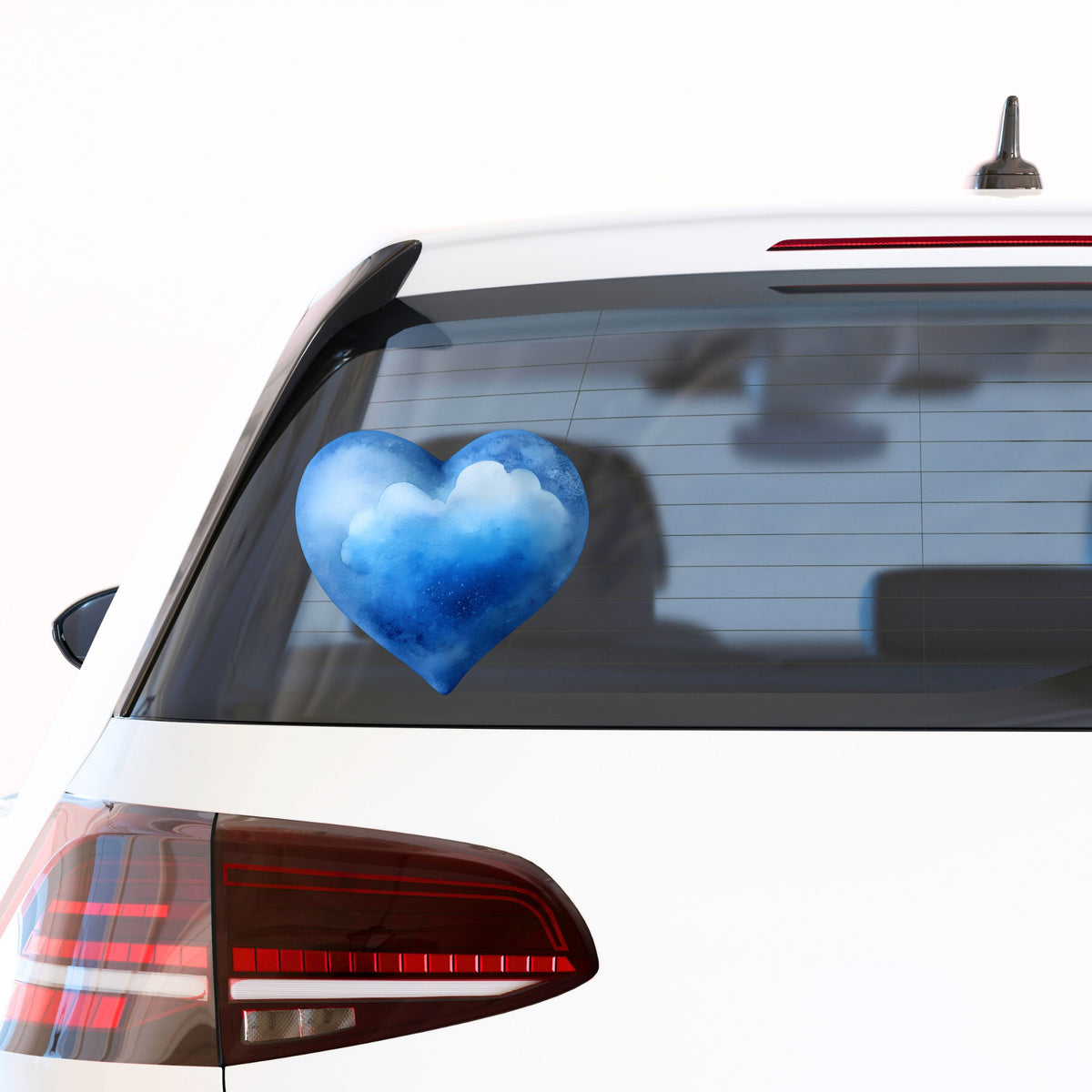 Blue Watercolor Heart With Clouds UV DTF sticker applied to the rear window of a white car