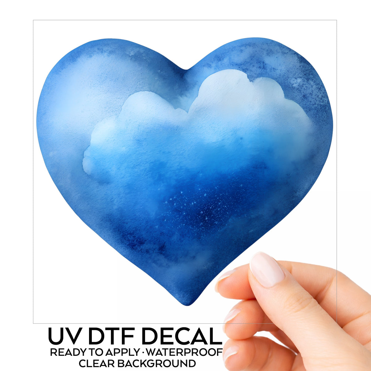 Blue Watercolor Heart With Clouds UV DTF sticker on its backing card, held in hand