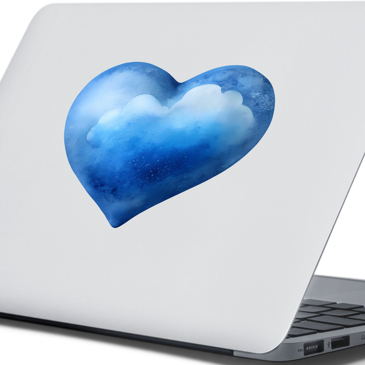 Blue Watercolor Heart With Clouds UV DTF sticker applied to the lid of a silver laptop
