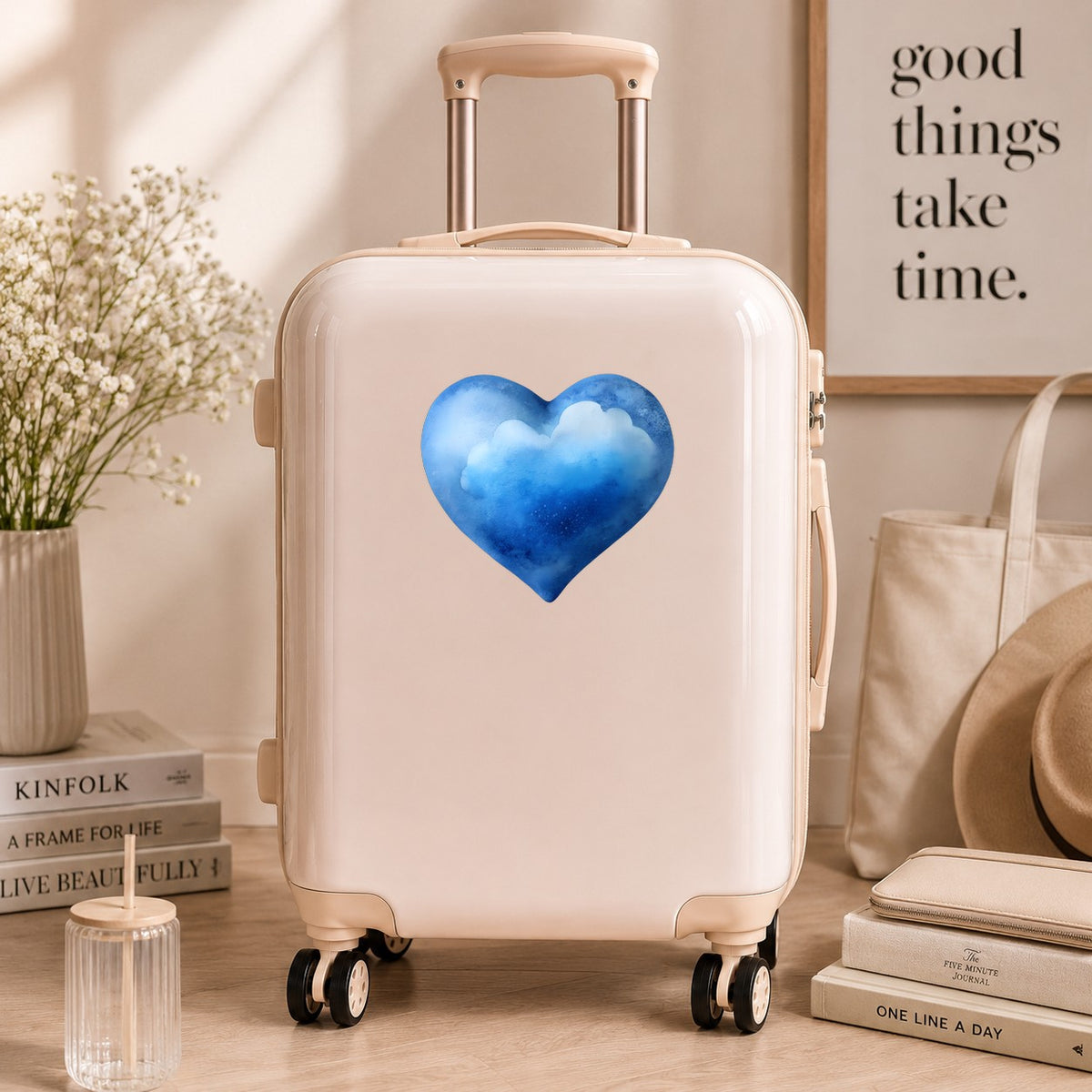 Blue Watercolor Heart With Clouds UV DTF sticker applied to a cream carry-on suitcase