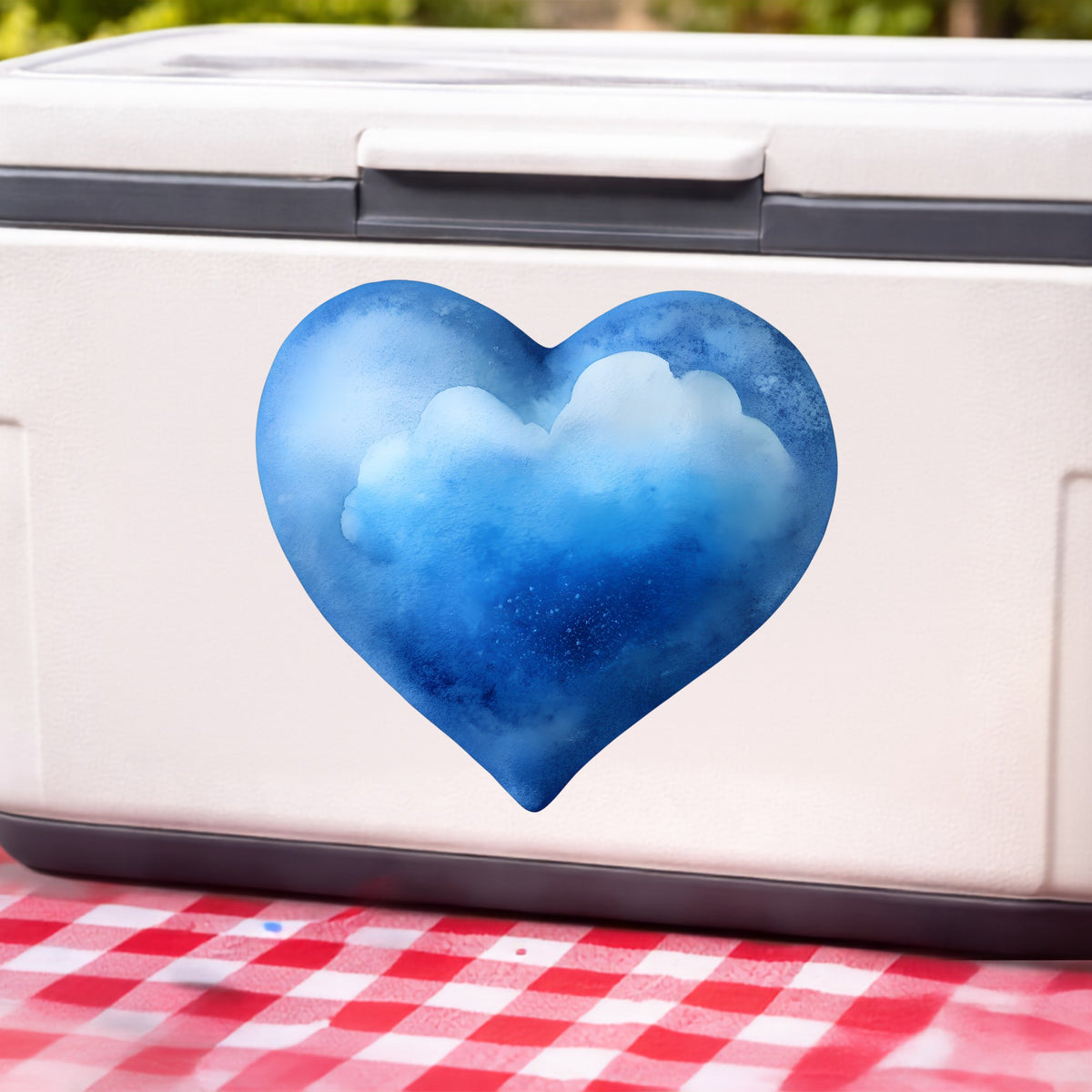 Blue Watercolor Heart With Clouds UV DTF sticker applied to a white cooler on a red gingham cloth