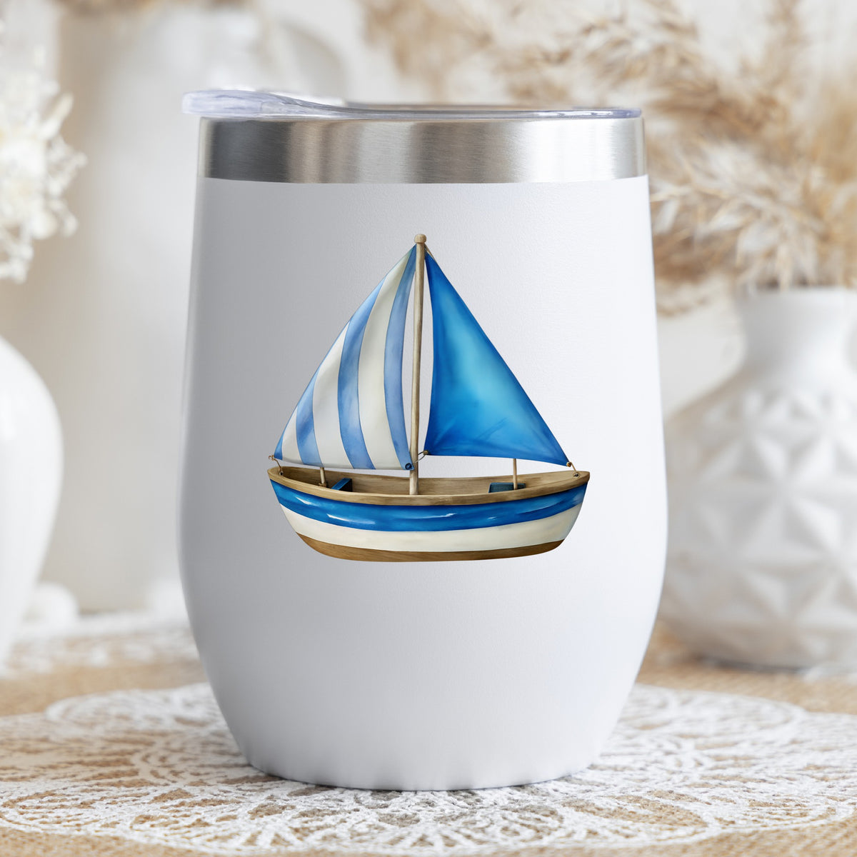 Blue Striped Sailboat UV DTF sticker applied to a white stemless tumbler with a lid