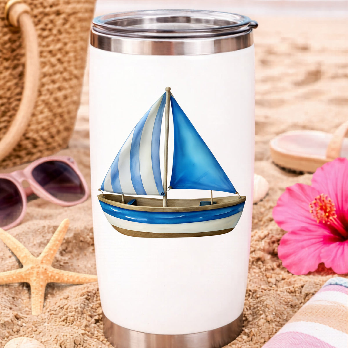 Blue Striped Sailboat UV DTF sticker applied to a white travel tumbler on beach sand
