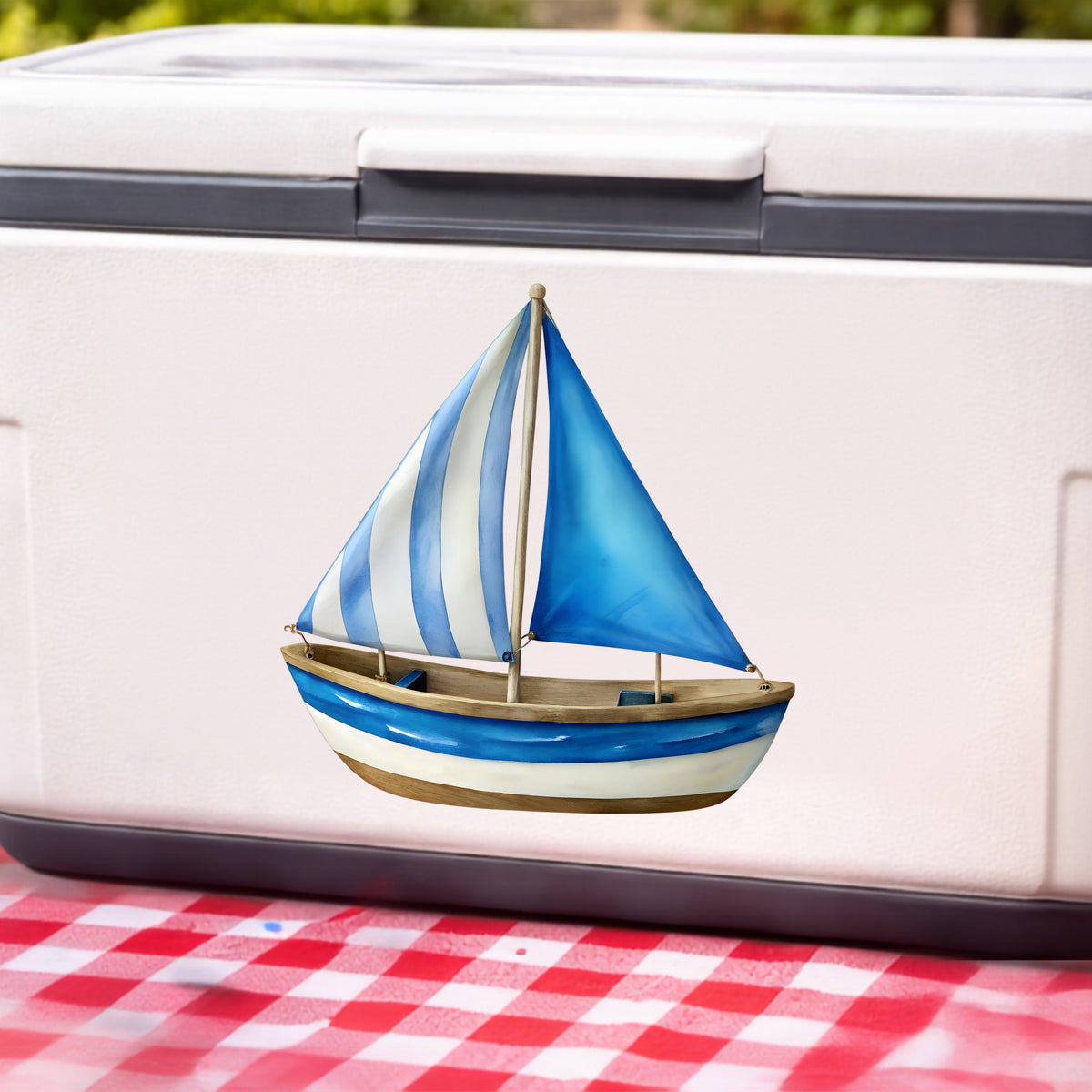 Blue Striped Sailboat UV DTF sticker applied to a white cooler on a red gingham cloth