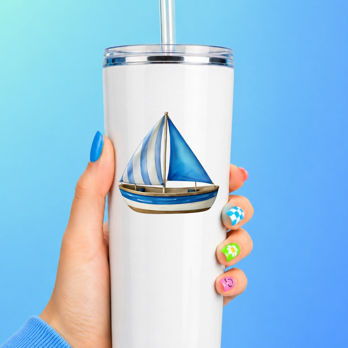 Blue Striped Sailboat UV DTF sticker applied to a white straw tumbler on a blue background