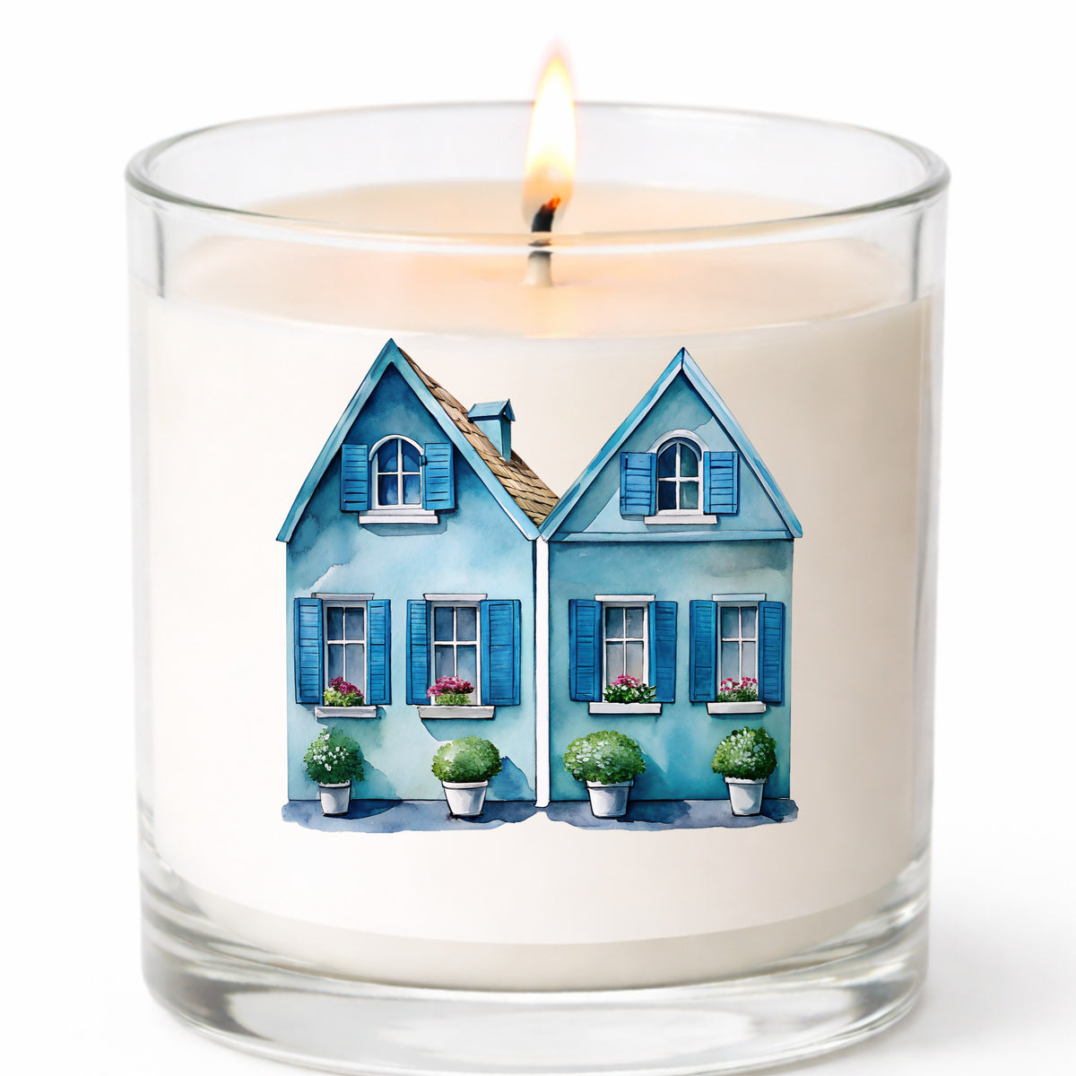 Two Blue Coastal Cottages UV DTF sticker applied to a white candle in a clear glass jar