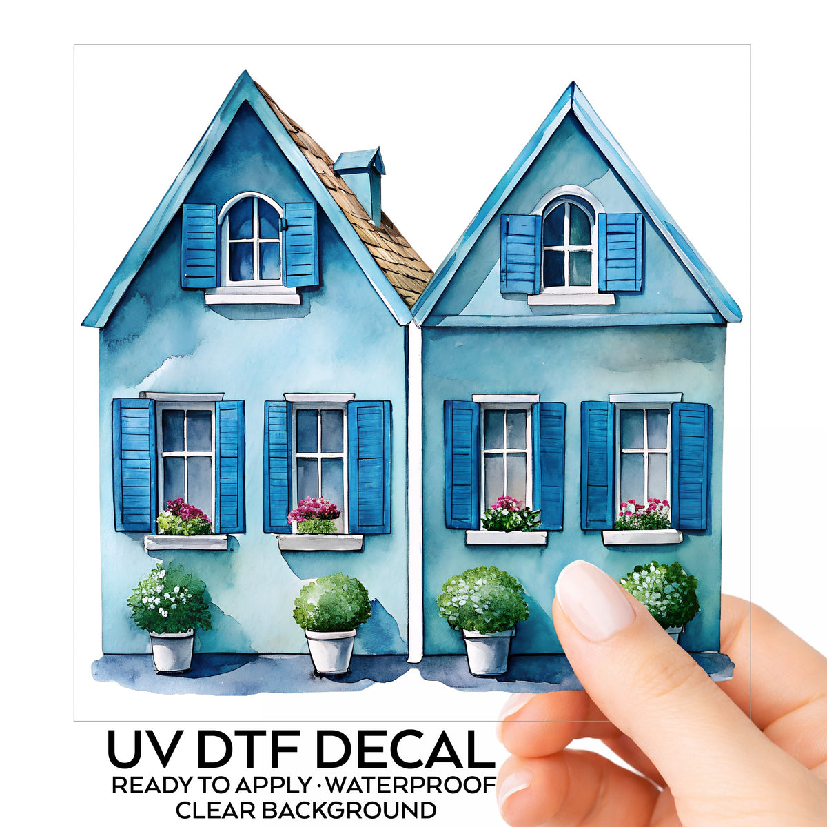 Two Blue Coastal Cottages UV DTF sticker on its backing card, held in hand