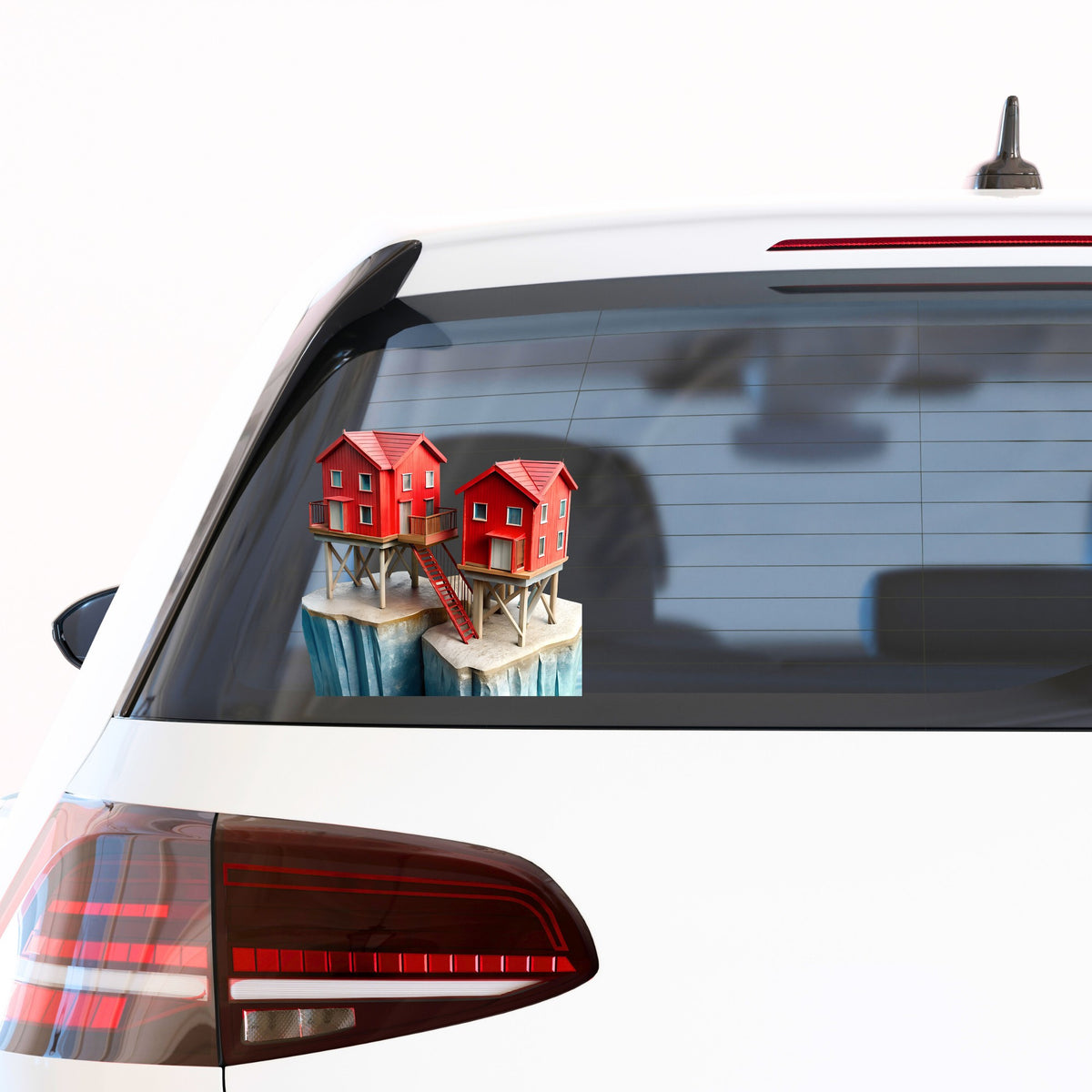 Red Houses On Stilts Cliff UV DTF sticker applied to the rear window of a white car