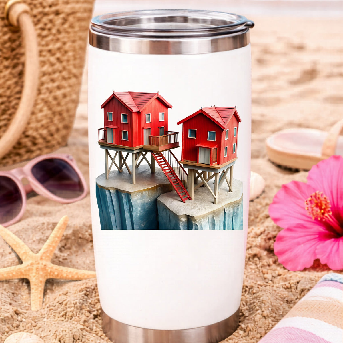 Red Houses On Stilts Cliff UV DTF sticker applied to a white travel tumbler on beach sand
