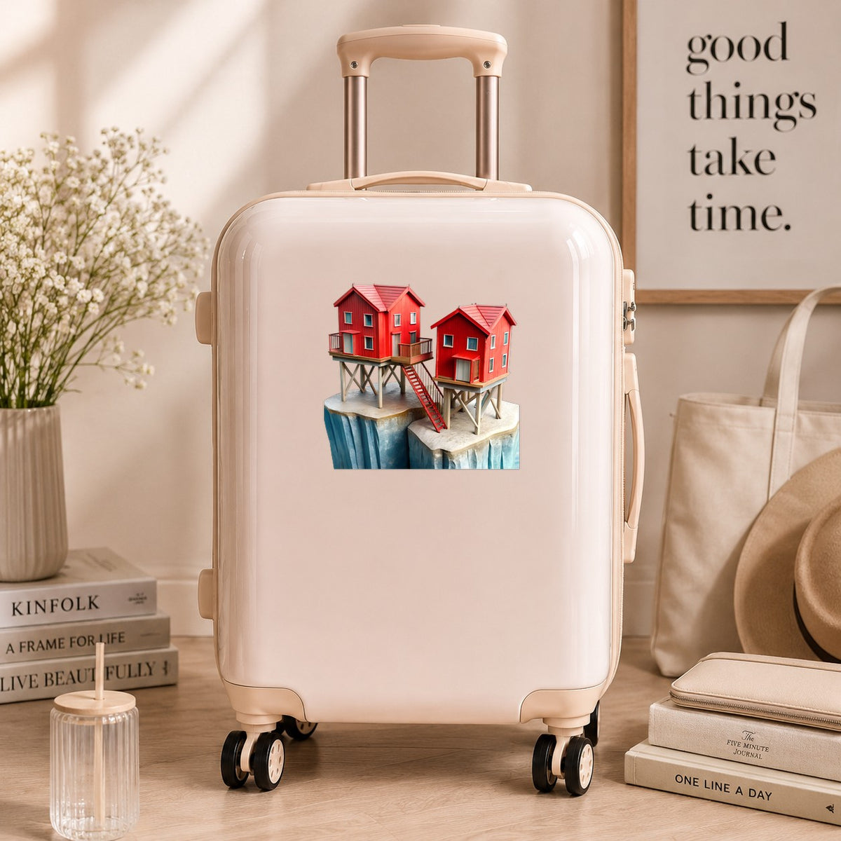 Red Houses On Stilts Cliff UV DTF sticker applied to a cream carry-on suitcase