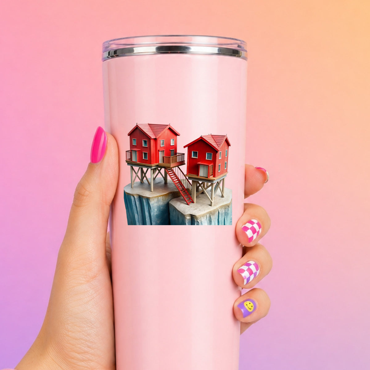 Red Houses On Stilts Cliff UV DTF sticker applied to a tall pink tumbler on a pink and orange background