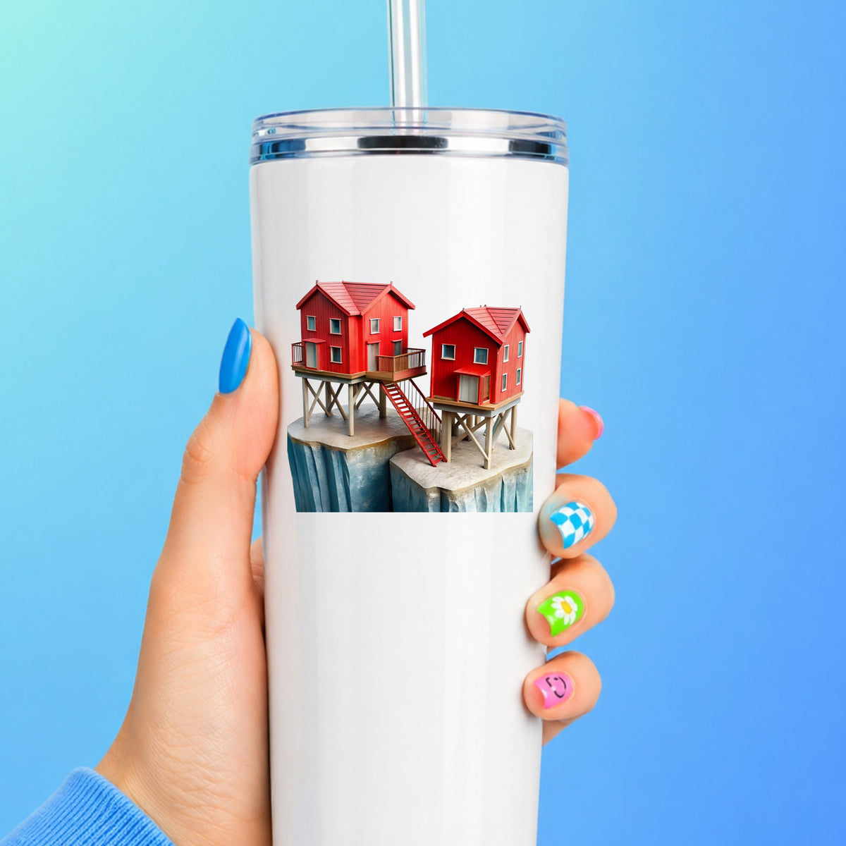 Red Houses On Stilts Cliff UV DTF sticker applied to a white straw tumbler on a blue background