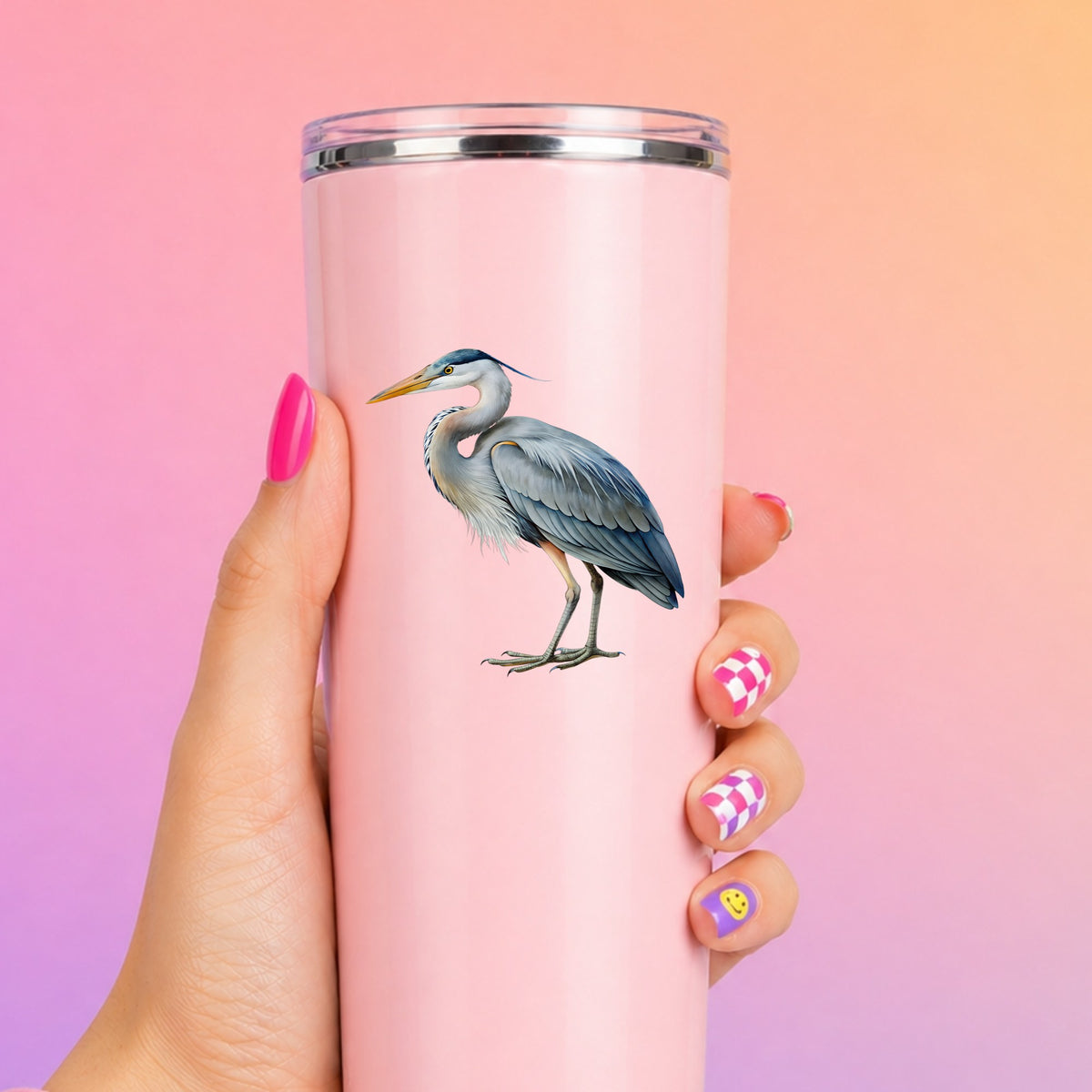 Great Blue Heron UV DTF sticker applied to a tall pink tumbler on a pink and orange background