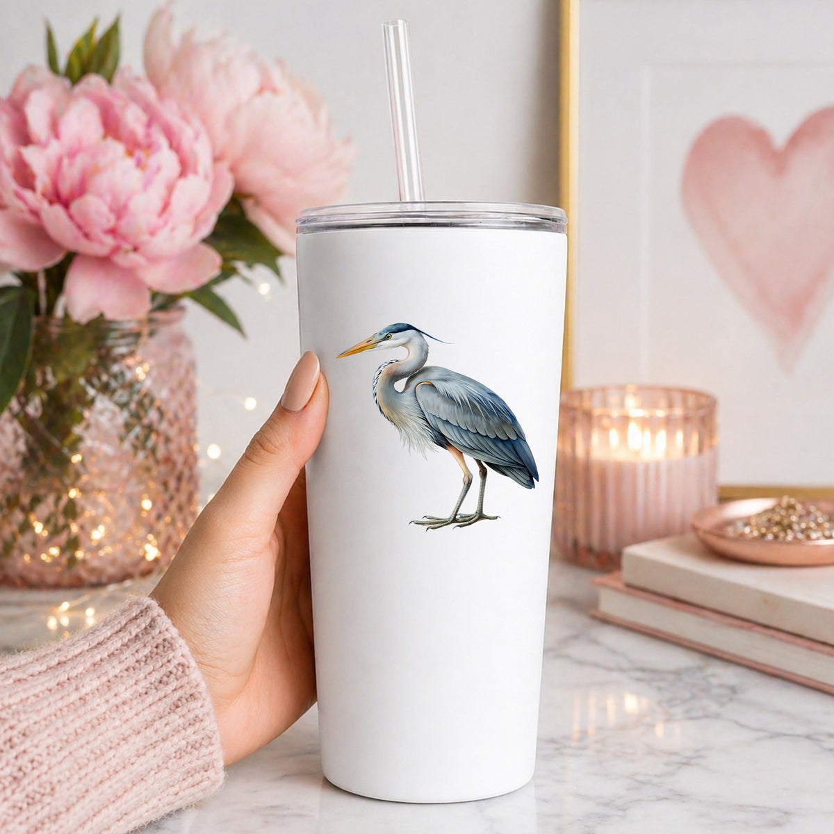 Great Blue Heron UV DTF sticker applied to a white straw tumbler beside pink peonies