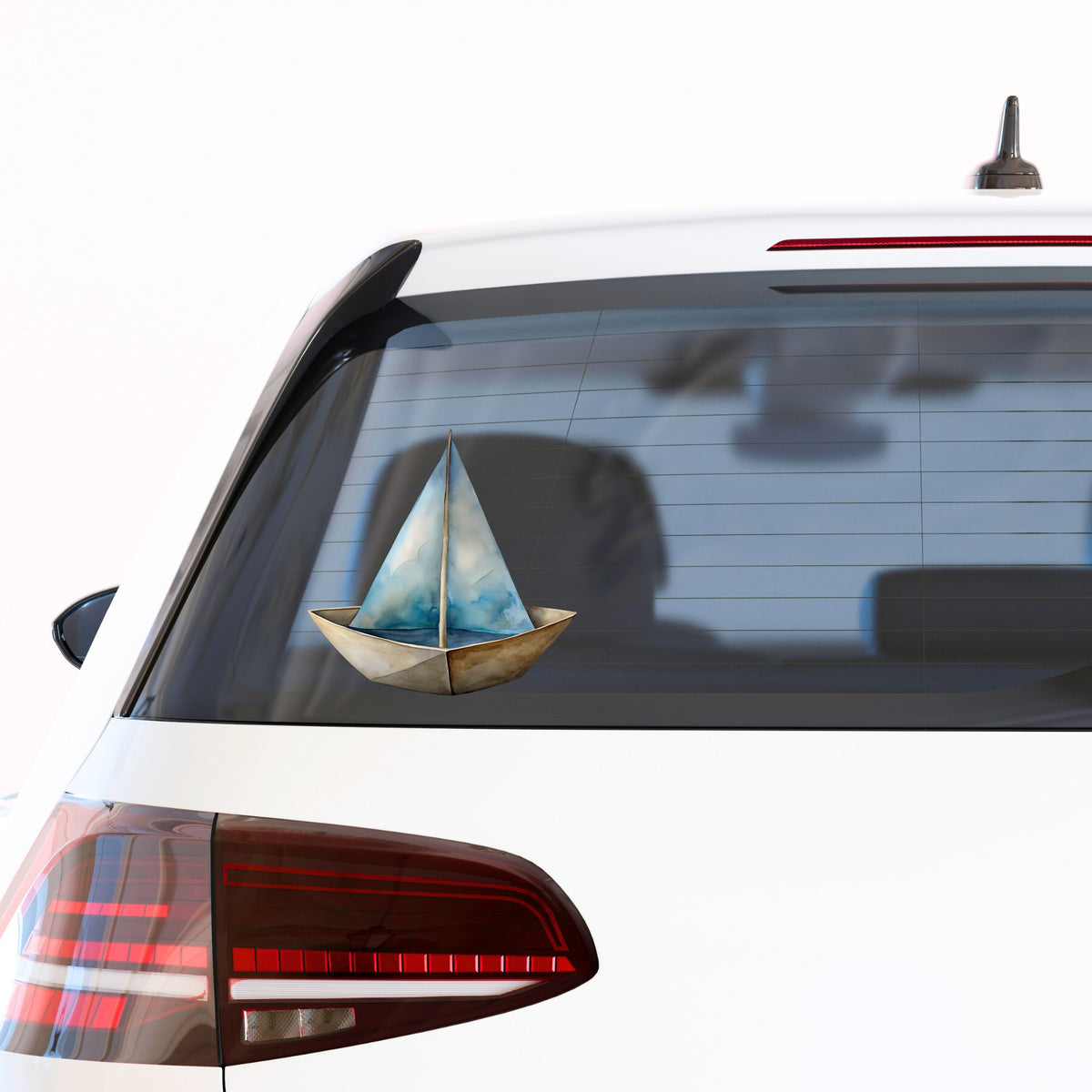 Paper Sailboat UV DTF sticker applied to the rear window of a white car