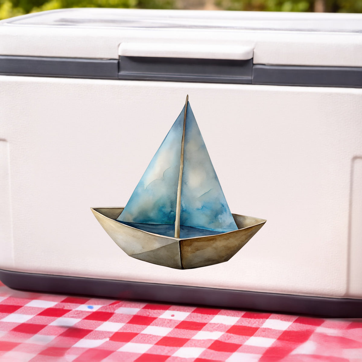 Paper Sailboat UV DTF sticker applied to a white cooler on a red gingham cloth