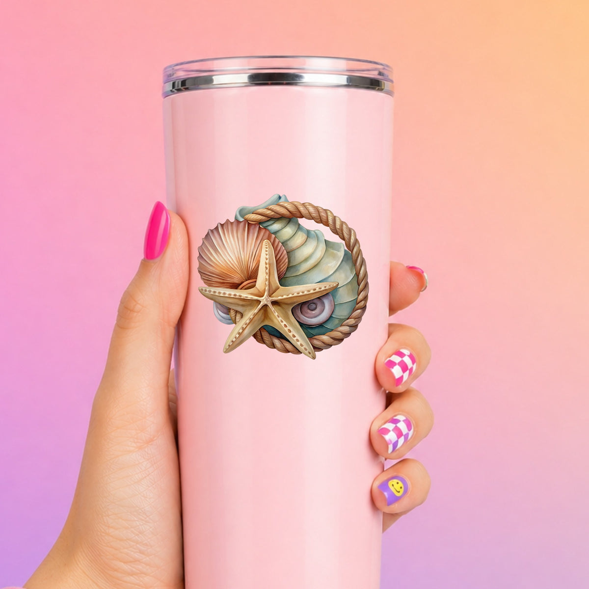 Seashells Starfish Rope Circle UV DTF sticker applied to a tall pink tumbler on a pink and orange background