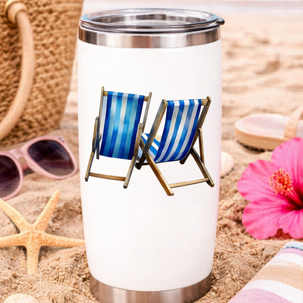 Two Blue Striped Beach Chairs UV DTF sticker applied to a white travel tumbler on beach sand
