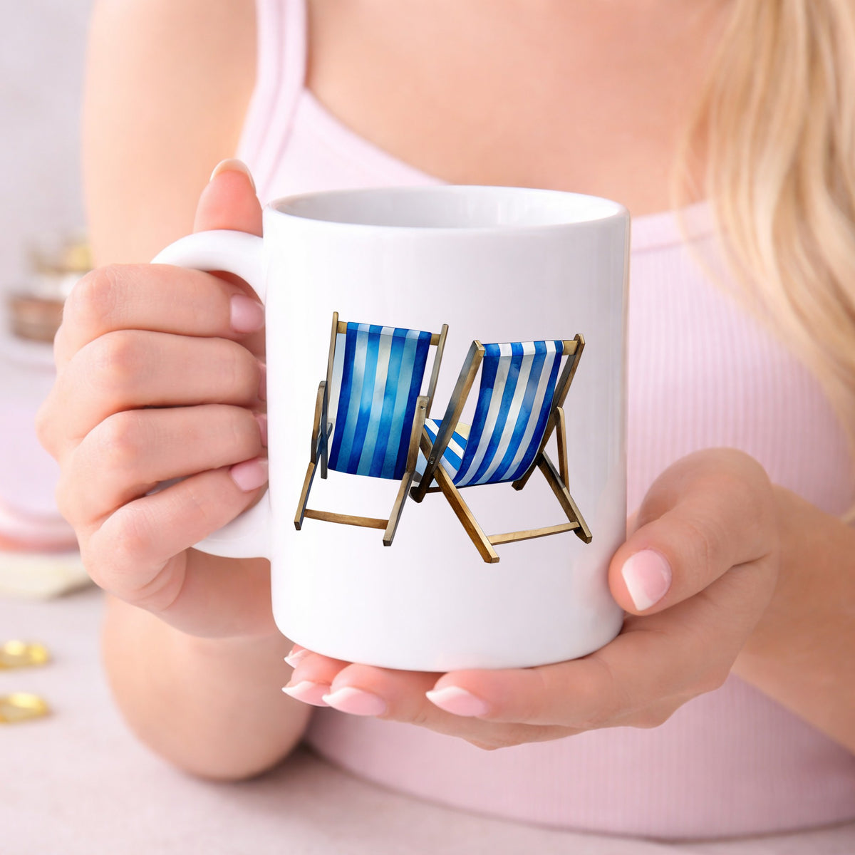 Two Blue Striped Beach Chairs UV DTF sticker applied to a white coffee mug held in both hands