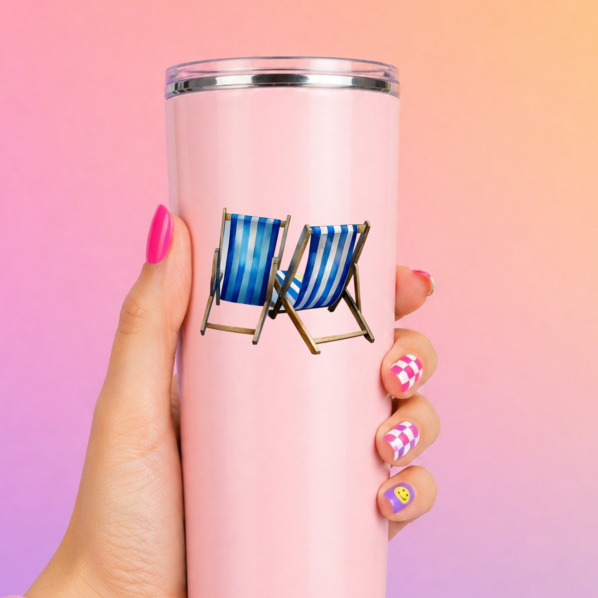 Two Blue Striped Beach Chairs UV DTF sticker applied to a tall pink tumbler on a pink and orange background