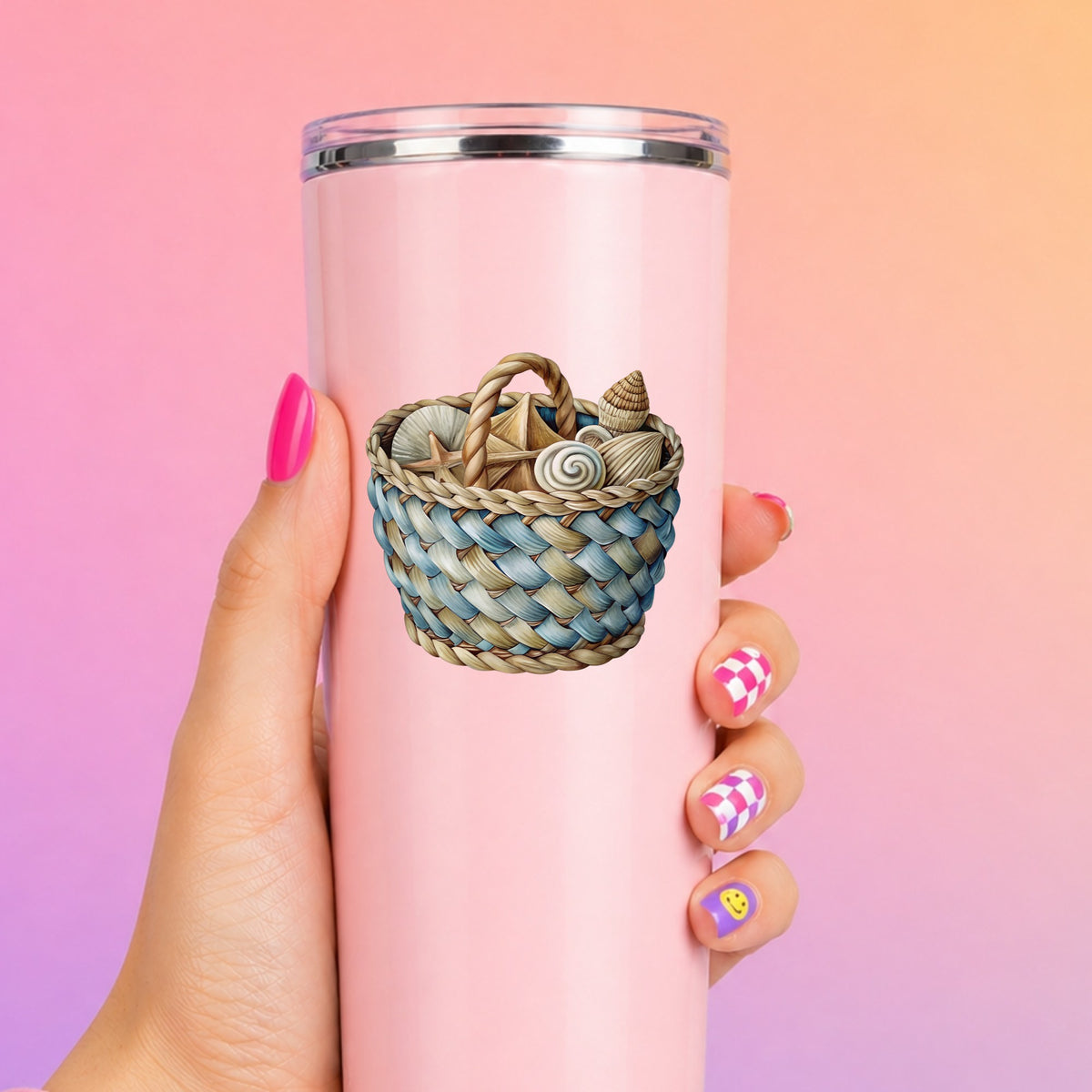 Woven Basket Of Seashells UV DTF sticker applied to a tall pink tumbler on a pink and orange background