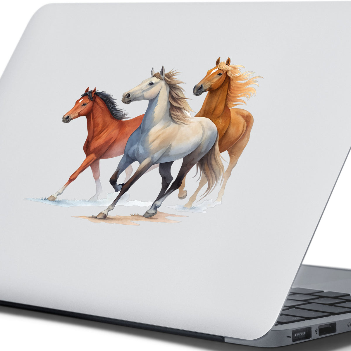 Three Horses Running UV DTF sticker applied to the lid of a silver laptop