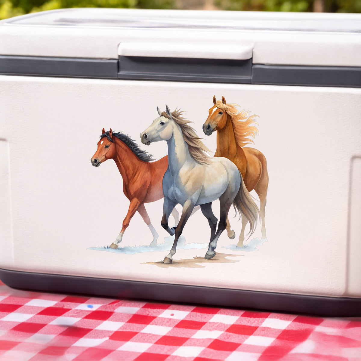 Three Horses Running UV DTF sticker applied to a white cooler on a red gingham cloth