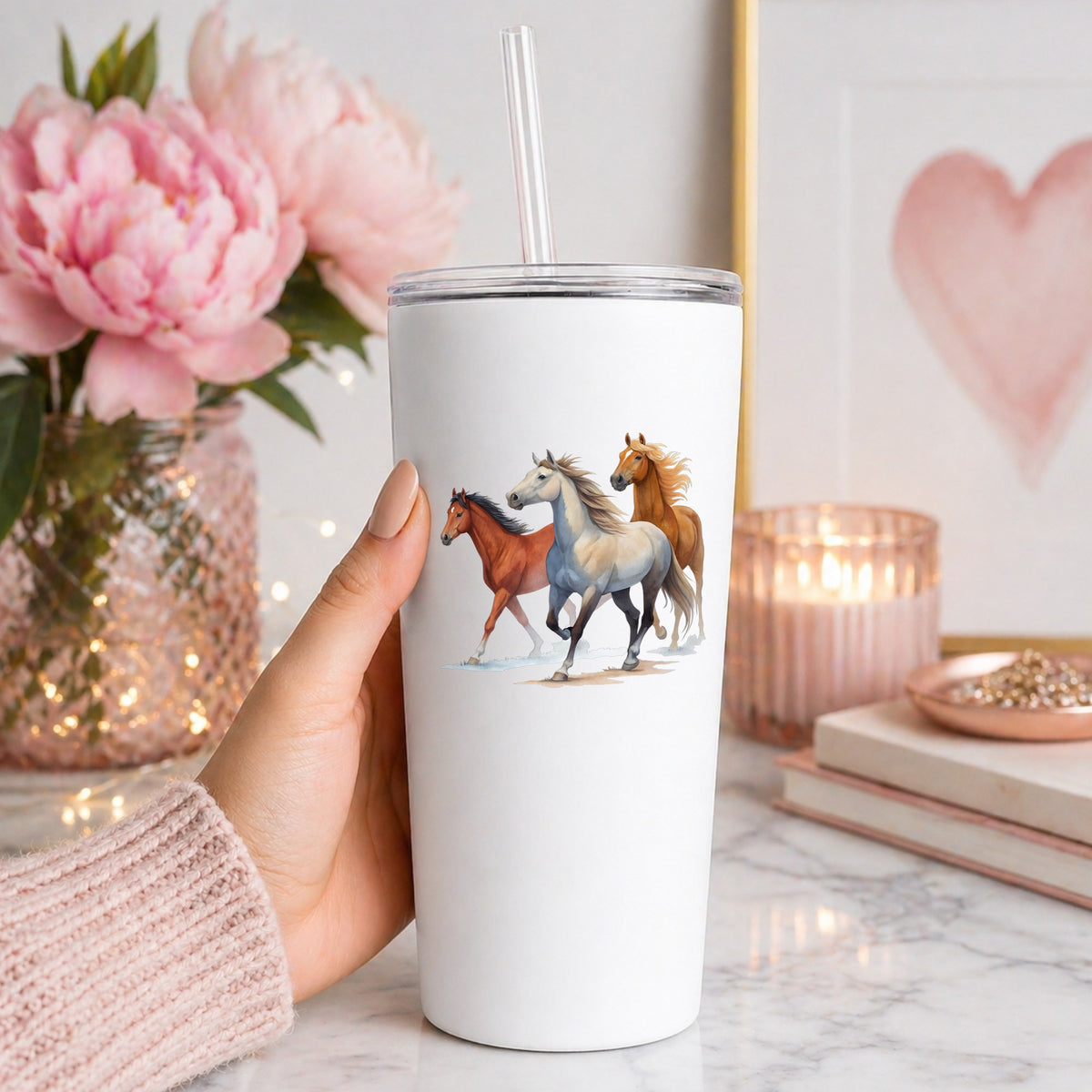 Three Horses Running UV DTF sticker applied to a white straw tumbler beside pink peonies