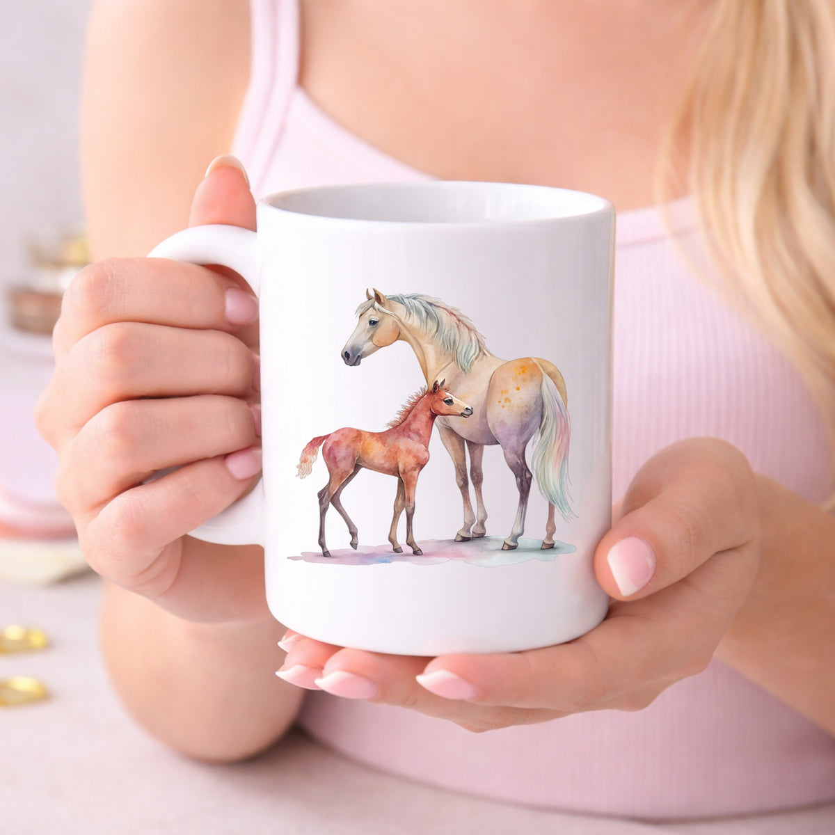 Pastel Mare And Pink Foal UV DTF sticker applied to a white coffee mug held in both hands