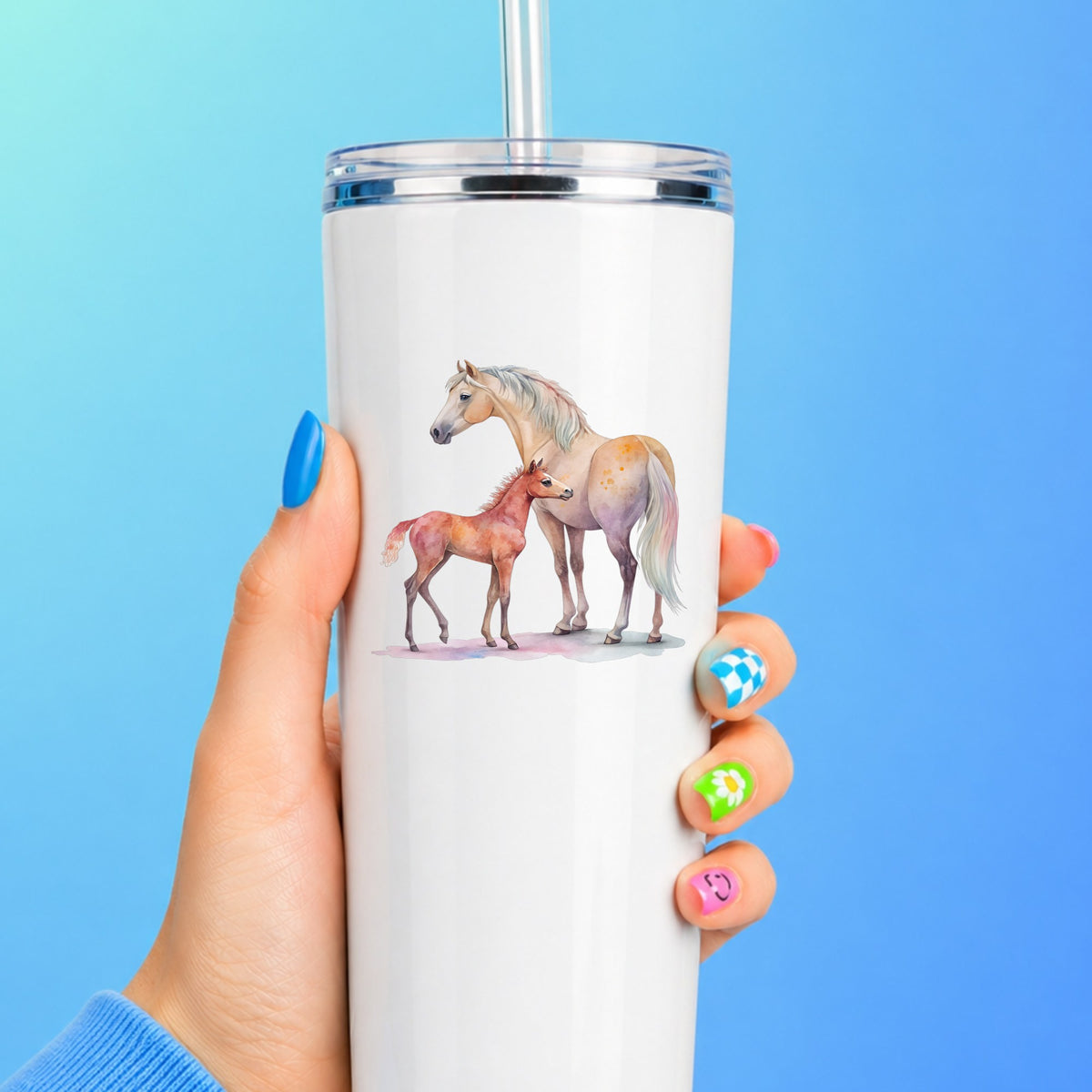 Pastel Mare And Pink Foal UV DTF sticker applied to a white straw tumbler on a blue background