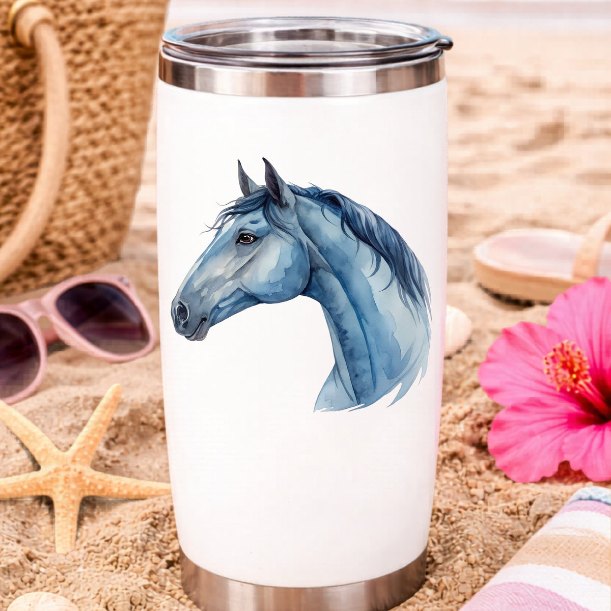 Blue Horse Head UV DTF sticker applied to a white travel tumbler on beach sand