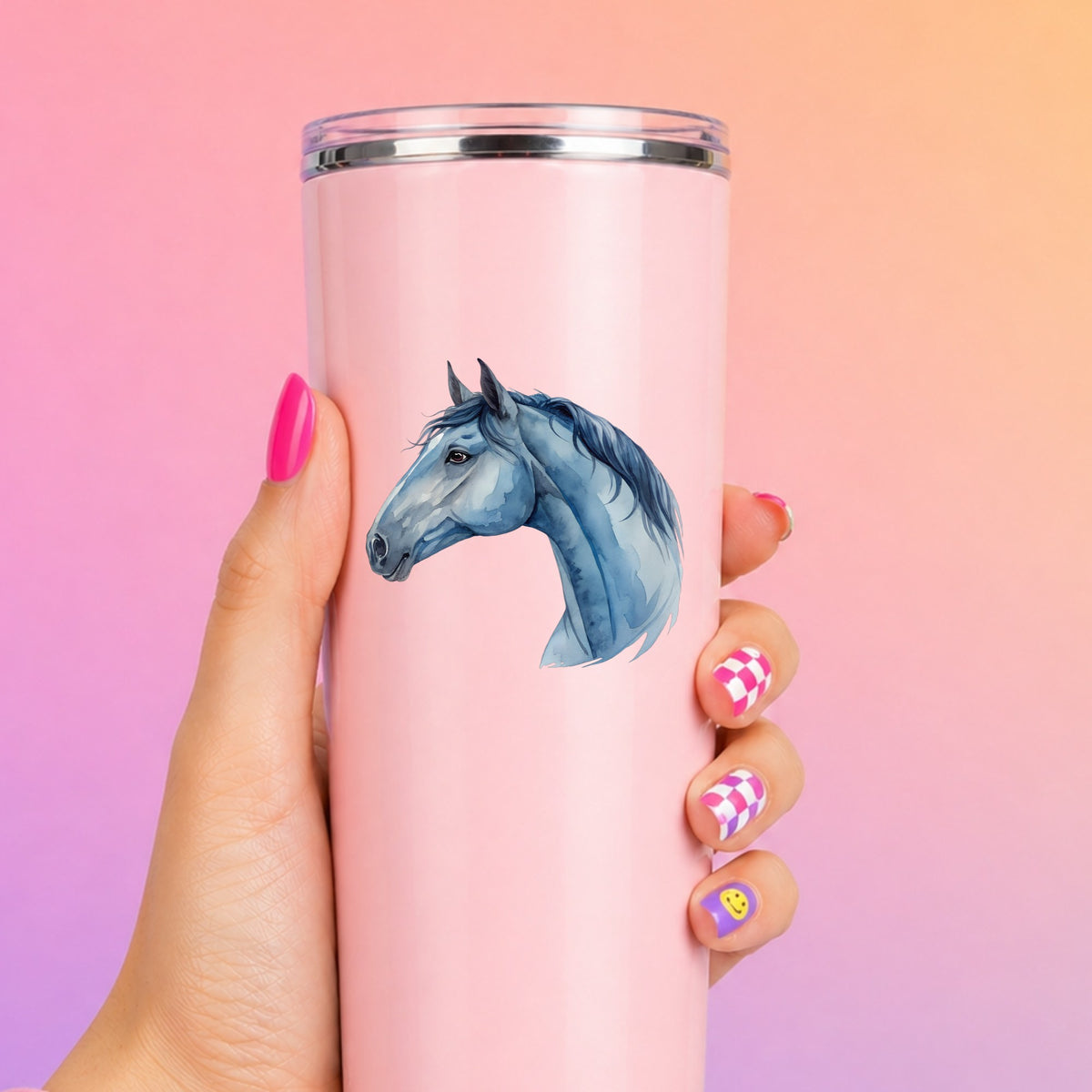 Blue Horse Head UV DTF sticker applied to a tall pink tumbler on a pink and orange background