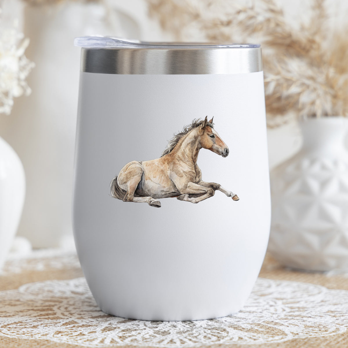 Buckskin Foal Lying Down UV DTF sticker applied to a white stemless tumbler with a lid
